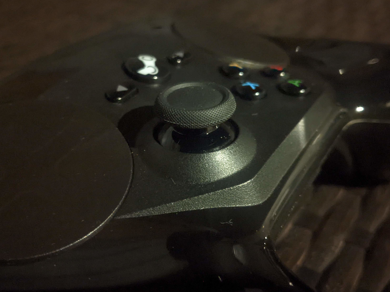 Steam Controller with a new replacement thumbstick, under unnecessarily dramatic lighting